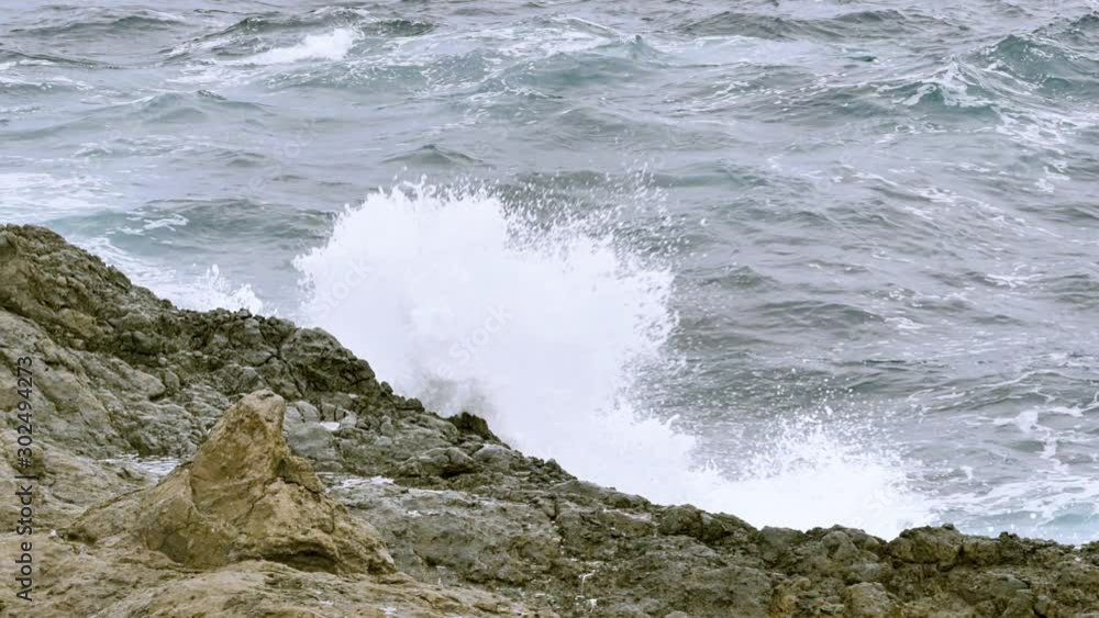 A mesmerizing view of soft ripples of water flowing and clashing against the rocks at an island.Slow motion.Static footage. A mesmerizing view of soft ripples of water flowing and clashing against the rocks at an island.Slow motion.Static footage.