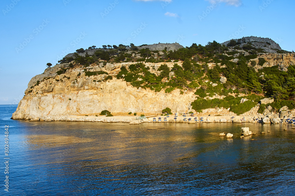 rocky cliff and beach at the edge of the Mediterranean Sea, on the island of Rhodes.
