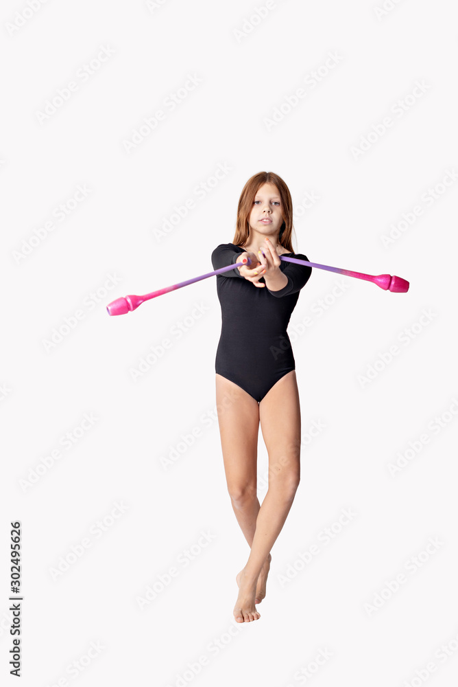 girl gymnast trains with a gymnastic clubs on white background. children's professional sports. girl gymnast trains with a gymnastic clubs on white background. children's professional sports.