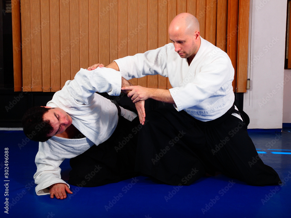 Martial arts practitioner doing a kneeling technique Martial arts practitioner doing a kneeling technique
