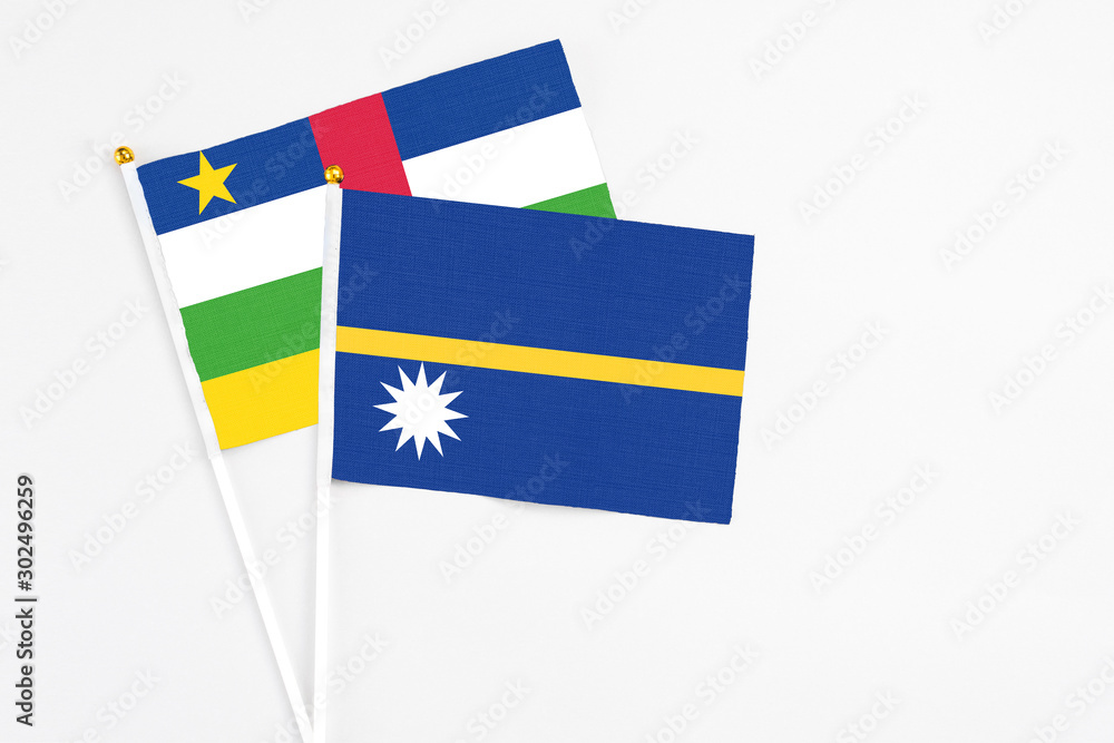 Nauru and Central African Republic stick flags on white background. High quality fabric, miniature national flag. Peaceful global concept.White floor for copy space. Nauru and Central African Republic stick flags on white background. High quality fabric, miniature national flag. Peaceful global concept.White floor for copy space.