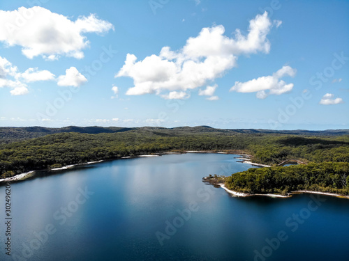 Drone shot over Lake McKenzie on Fraser Island looking from the main beach towards the forest