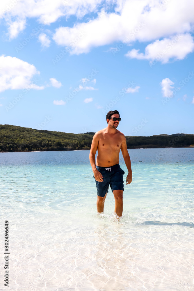 Caucasion guy walking out of Lake McKenzie on Fraser Island, Australia Caucasion guy walking out of Lake McKenzie on Fraser Island, Australia