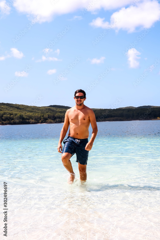 Caucasion guy walking out of Lake McKenzie on Fraser Island, Australia Caucasion guy walking out of Lake McKenzie on Fraser Island, Australia