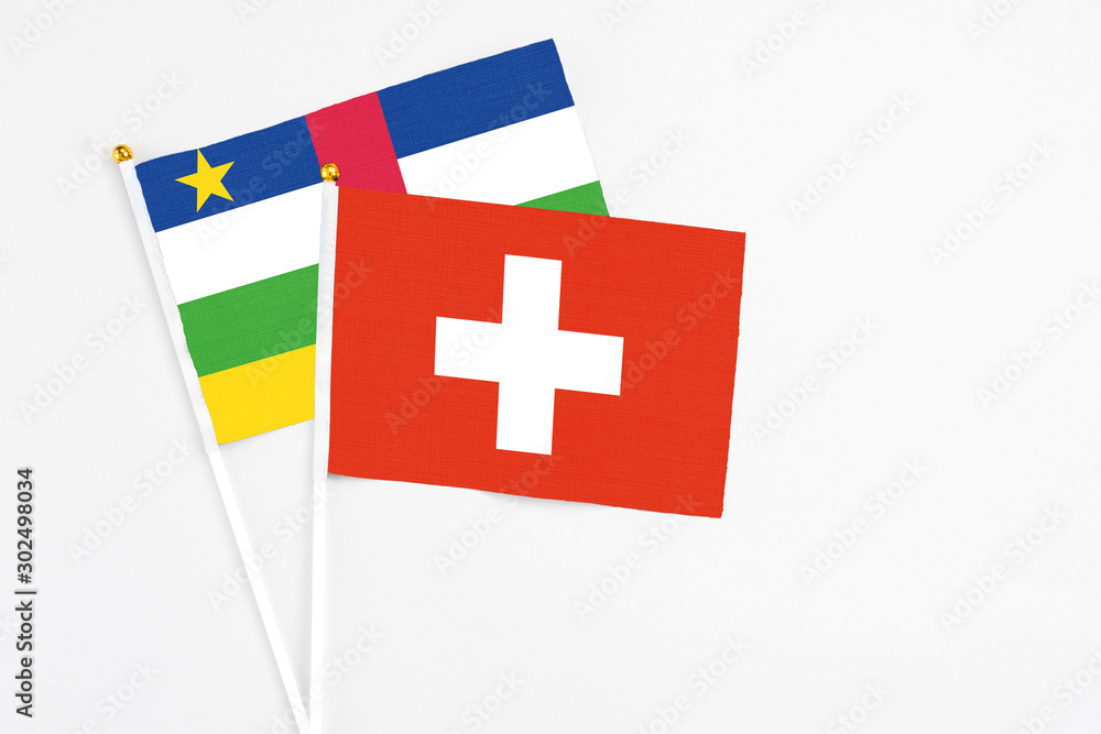 Switzerland and Central African Republic stick flags on white background. High quality fabric, miniature national flag. Peaceful global concept.White floor for copy space.