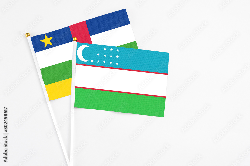 Uzbekistan and Central African Republic stick flags on white background. High quality fabric, miniature national flag. Peaceful global concept.White floor for copy space. Uzbekistan and Central African Republic stick flags on white background. High quality fabric, miniature national flag. Peaceful global concept.White floor for copy space.
