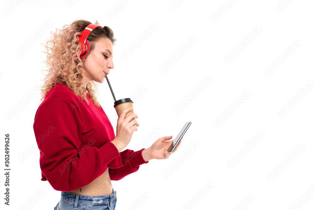 Naklejka premium Caucasian girl with curly fair hair drinks coffe, listen to music and talking with friends, portrait isolated on white background