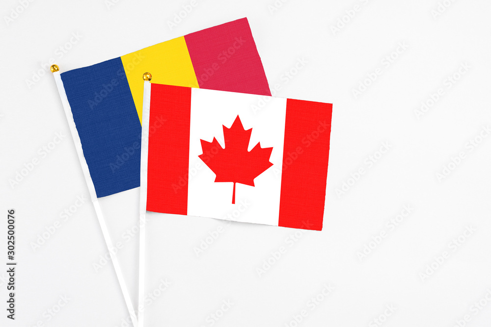 Canada and Chad stick flags on white background. High quality fabric, miniature national flag. Peaceful global concept.White floor for copy space. Canada and Chad stick flags on white background. High quality fabric, miniature national flag. Peaceful global concept.White floor for copy space.