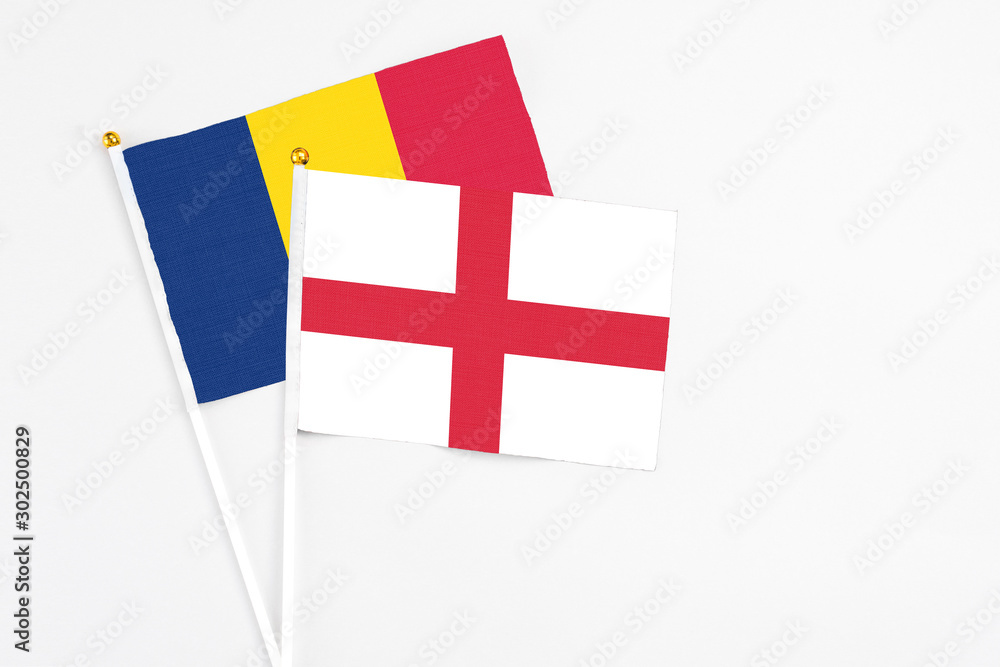 England and Chad stick flags on white background. High quality fabric, miniature national flag. Peaceful global concept.White floor for copy space.