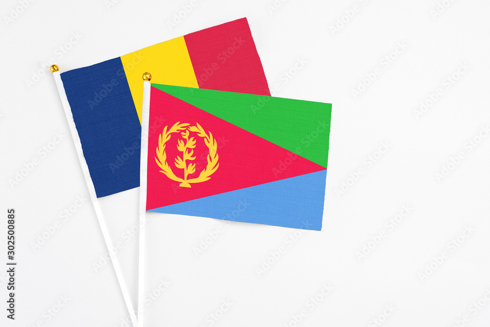 Eritrea and Chad stick flags on white background. High quality fabric, miniature national flag. Peaceful global concept.White floor for copy space. Eritrea and Chad stick flags on white background. High quality fabric, miniature national flag. Peaceful global concept.White floor for copy space.