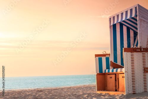 Beach chair and beach at sunset on Sylt. Summer vacation context photo