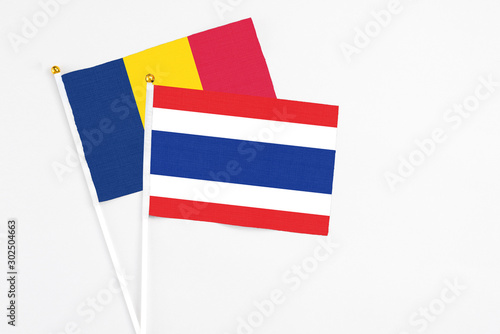 Thailand and Chad stick flags on white background. High quality fabric, miniature national flag. Peaceful global concept.White floor for copy space. photo