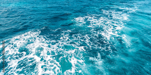 Fototapeta Naklejka Na Ścianę i Meble -  Boat wake prop wash on blue ocean sea in sunny day
