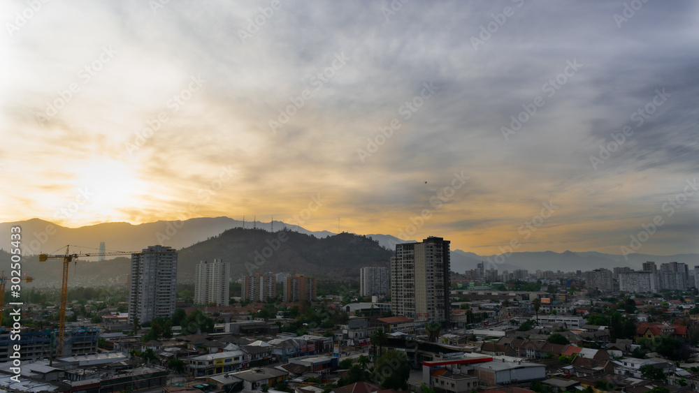Fototapeta premium city and hill at dawn with construction crane