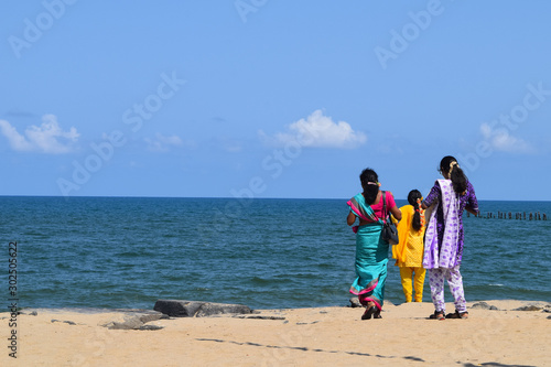 Tree woman in colorful traditional sari walking at promenade in Pondicherry, former french colony in India