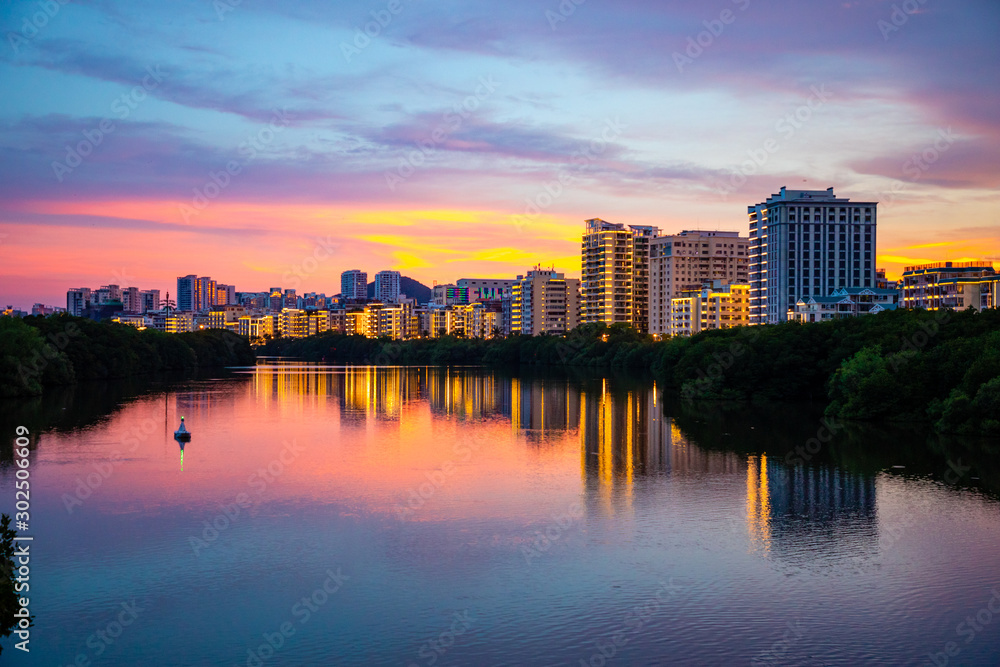 Fototapeta premium Sanya Cityscape with Sanya River View and Apartment Buildings in the sunset time, Hainan Province, China