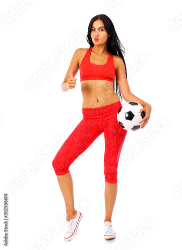 Fitness woman in a red sports suit with soccer balls