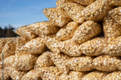 Stack of kettle corn in bags with a blue sky background photo