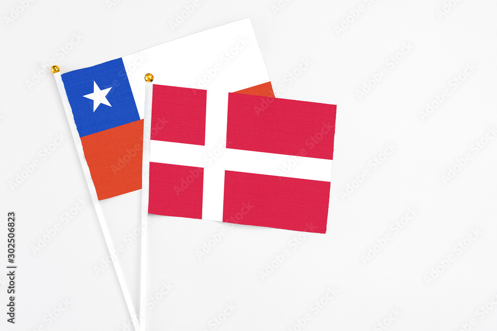 Denmark and Chile stick flags on white background. High quality fabric, miniature national flag. Peaceful global concept.White floor for copy space.