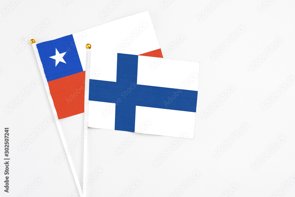 Finland and Chile stick flags on white background. High quality fabric, miniature national flag. Peaceful global concept.White floor for copy space.