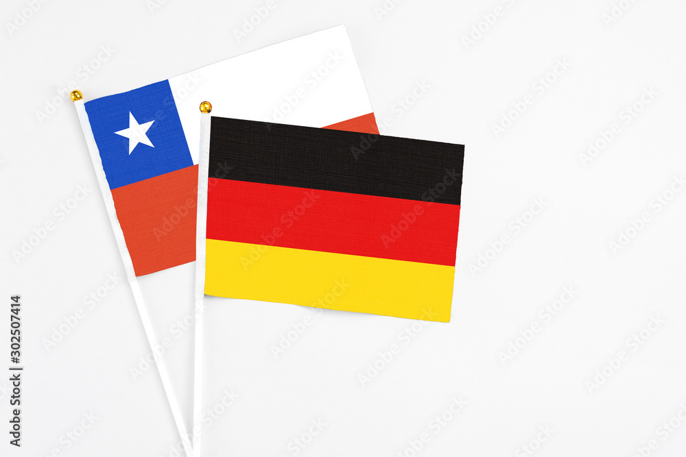 Germany and Chile stick flags on white background. High quality fabric, miniature national flag. Peaceful global concept.White floor for copy space. Germany and Chile stick flags on white background. High quality fabric, miniature national flag. Peaceful global concept.White floor for copy space.