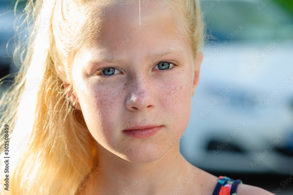 Beautiful little blonde girl with long hair in the park, summer ...