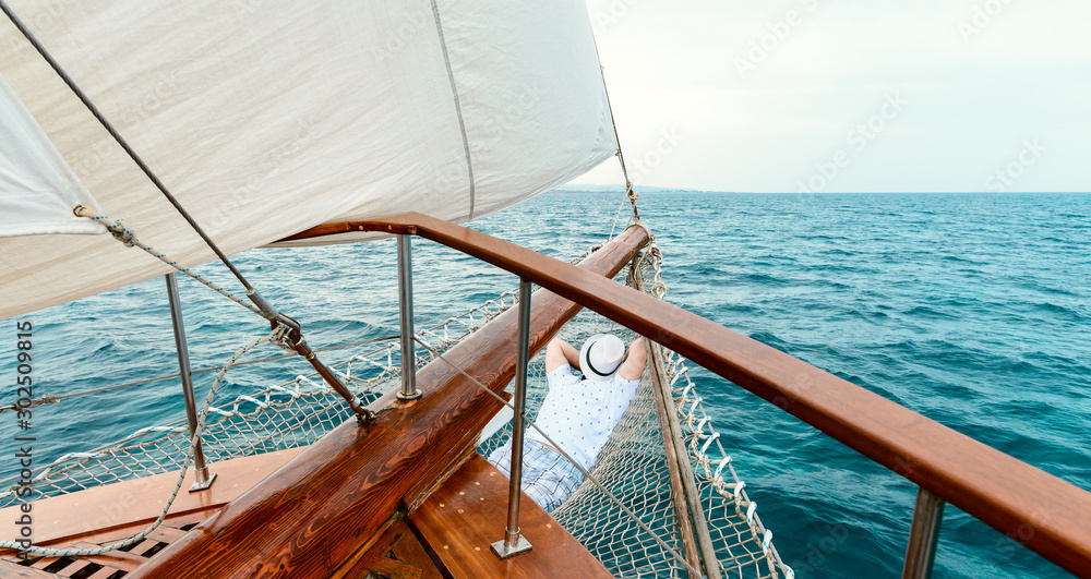 Fototapeta premium man resting or sleeping on the yacht, summer vacation