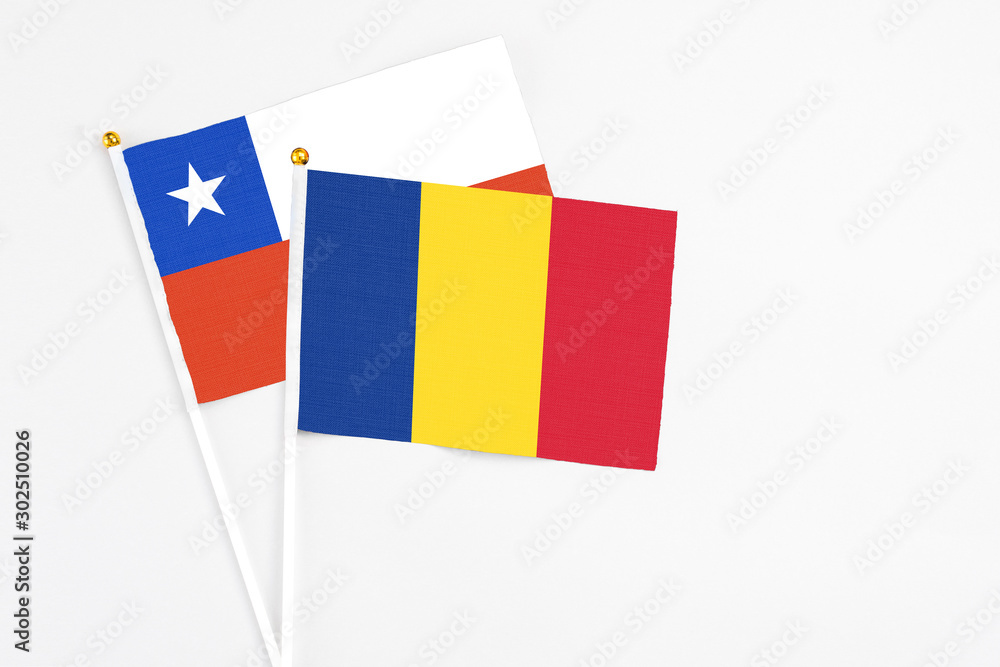 Romania and Chile stick flags on white background. High quality fabric, miniature national flag. Peaceful global concept.White floor for copy space. Romania and Chile stick flags on white background. High quality fabric, miniature national flag. Peaceful global concept.White floor for copy space.