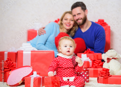 Love is the biggest treasure. father, mother and doughter child. Shopping. Love and trust in family. Bearded man and woman with little girl. Happy family with present box. Valentines day. Red boxes