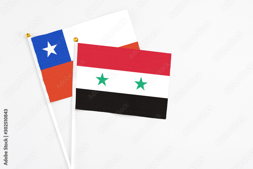 Syria and Chile stick flags on white background. High quality fabric, miniature national flag. Peaceful global concept.White floor for copy space. Syria and Chile stick flags on white background. High quality fabric, miniature national flag. Peaceful global concept.White floor for copy space.