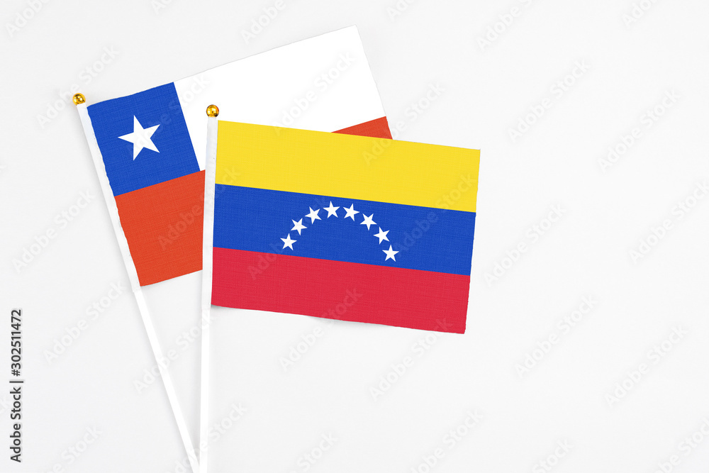 Venezuela and Chile stick flags on white background. High quality fabric, miniature national flag. Peaceful global concept.White floor for copy space. Venezuela and Chile stick flags on white background. High quality fabric, miniature national flag. Peaceful global concept.White floor for copy space.