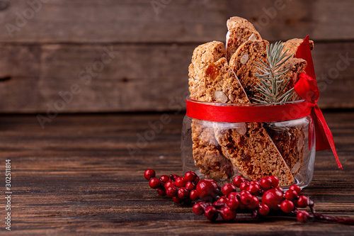 Slika na platnu Traditional italian Christmas New Year dry cookies biscuits biscotti cantuccini in glass bowl on wooden background