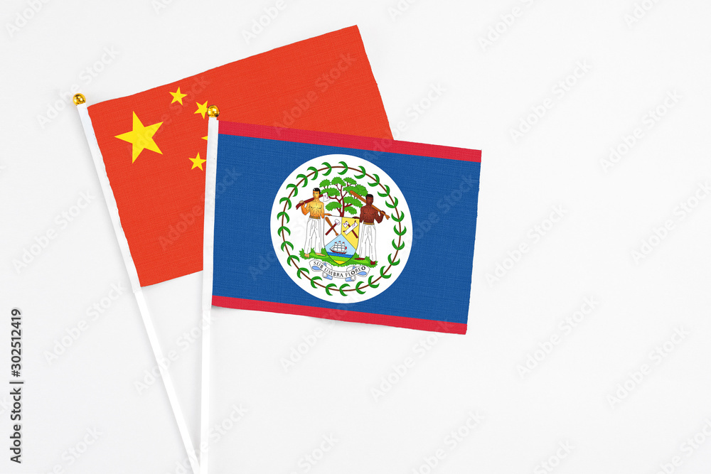 Belize and China stick flags on white background. High quality fabric, miniature national flag. Peaceful global concept.White floor for copy space. Belize and China stick flags on white background. High quality fabric, miniature national flag. Peaceful global concept.White floor for copy space.