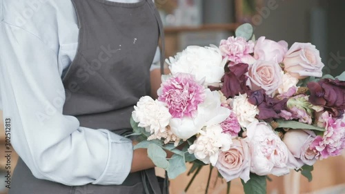 Florist making fresh flower bouquet in flower shop