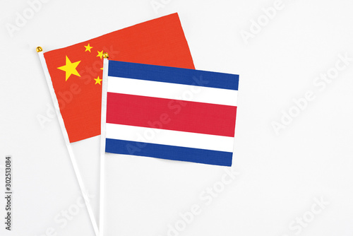 Free Download Costa Rica and China stick flags on white background. High quality fabric, miniature national flag. Peaceful global concept.White floor for copy space. - GFXLoad