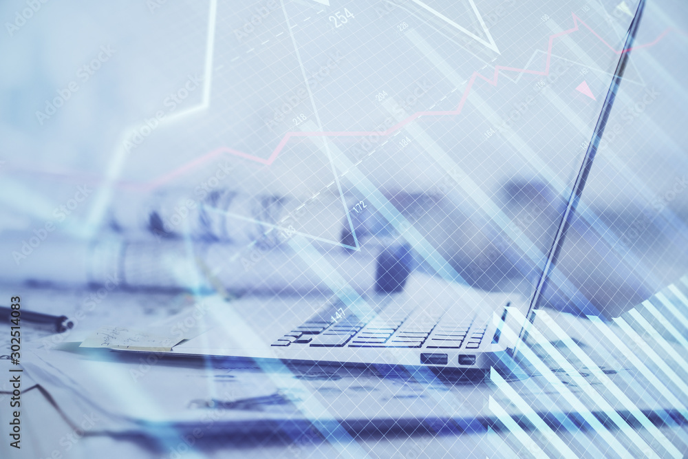 Stock market graph on background with desk and personal computer. Double exposure. Concept of financial analysis.