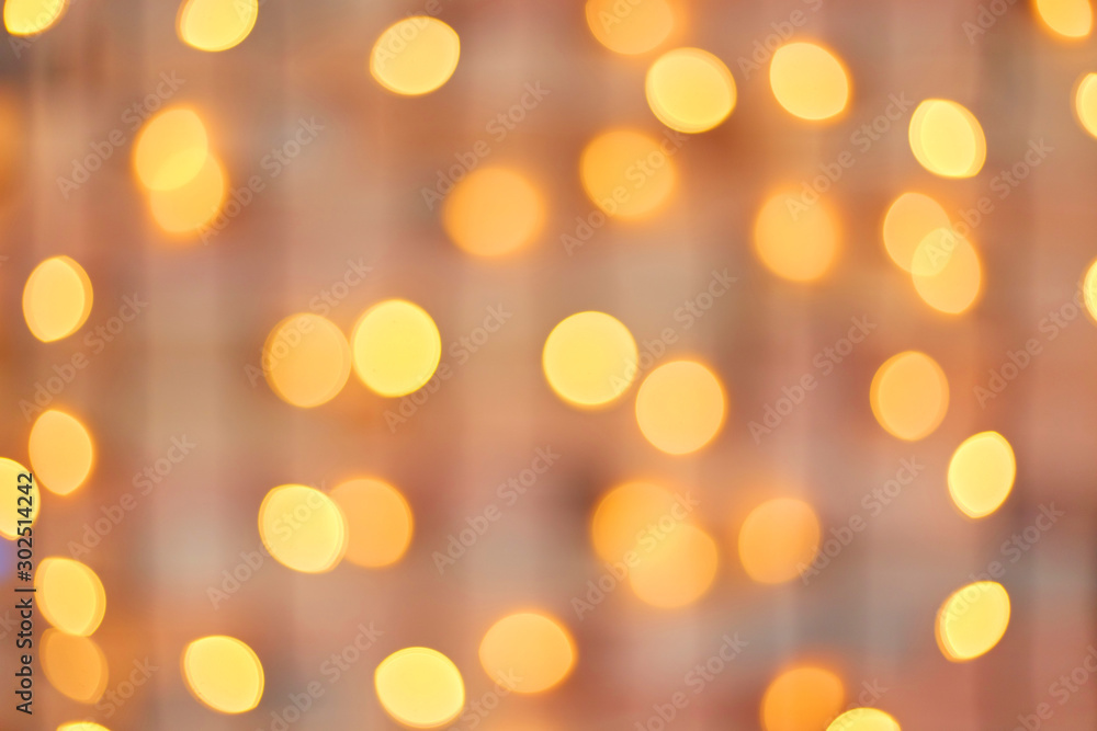 Obraz premium Golden beautiful blurred bokeh background with copy space.
