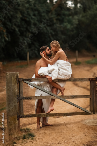 Young beautiful couple in rural area in blankets © arhar