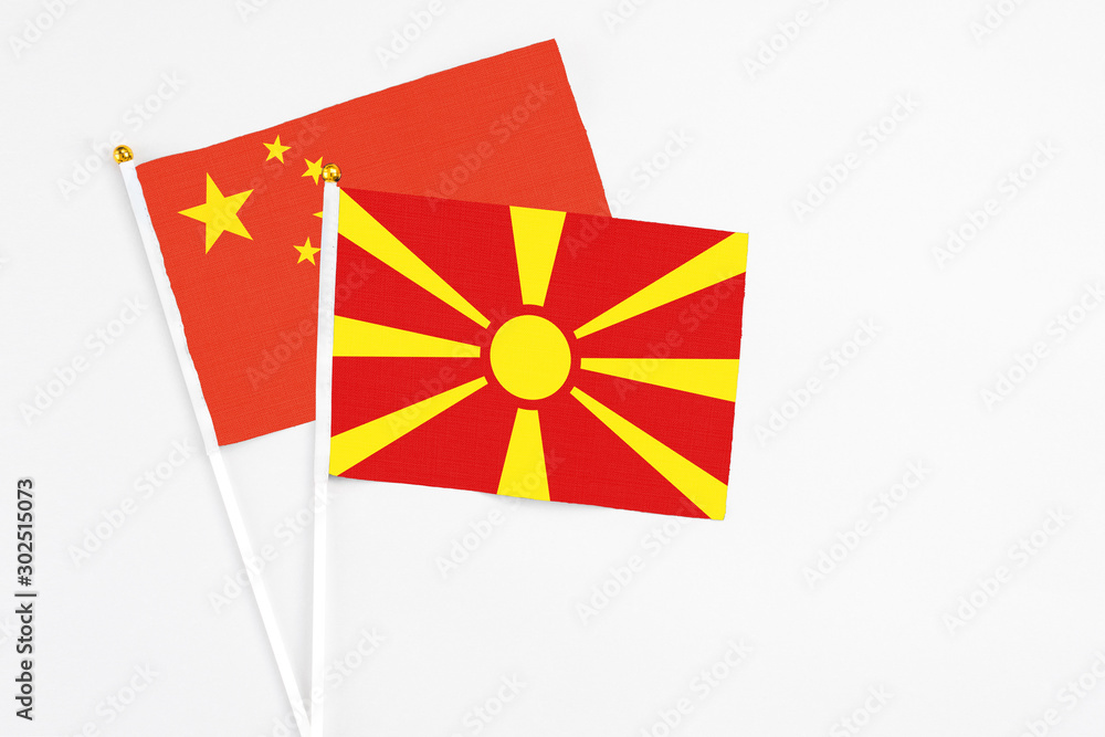 Macedonia and China stick flags on white background. High quality fabric, miniature national flag. Peaceful global concept.White floor for copy space.