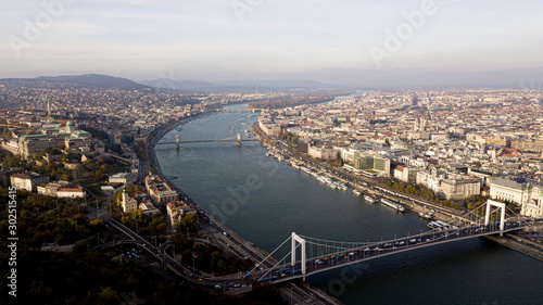 The highest point of Budapest with a view of the city panorama. A river with bridges and ships. Sunset sun. Chain bridge, palace and parliament. Top view.