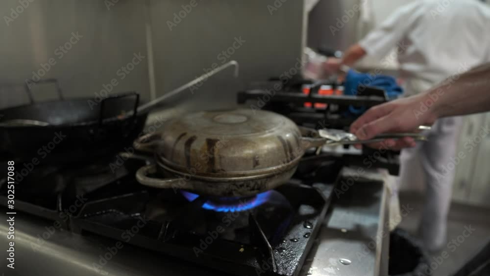 Chef cooking in a restaurant kitchen Chef cooking in a restaurant kitchen