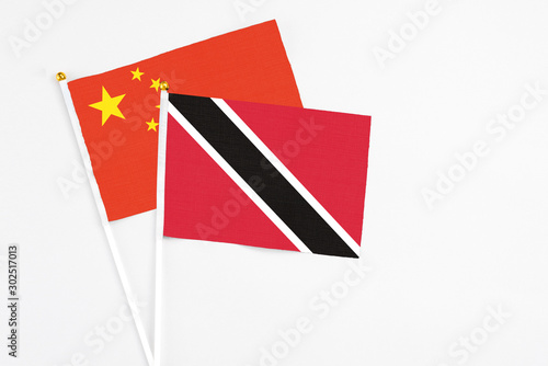 Free Download Trinidad And Tobago and China stick flags on white background. High quality fabric, miniature national flag. Peaceful global concept.White floor for copy space. - GFXLoad