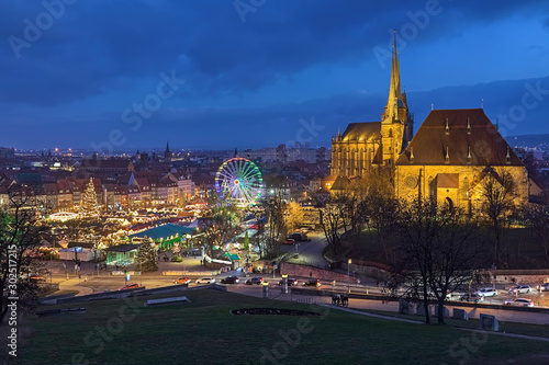 Erfurt, Germany. Christmas market on Domplatz (Cathedral Square) at the foot of Domberg (Cathedral Hill) with St Mary's Cathedral and Church of St Severus in dusk. View from Petersberg hill.  photo