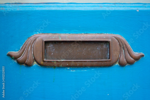 Ornate metal letterbox with wings or hair © nowyn