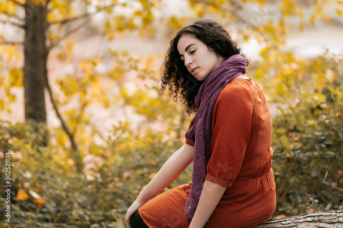 Young woman  dressed in casual clothes  with relaxed attitude  in a forest with autumn colors.