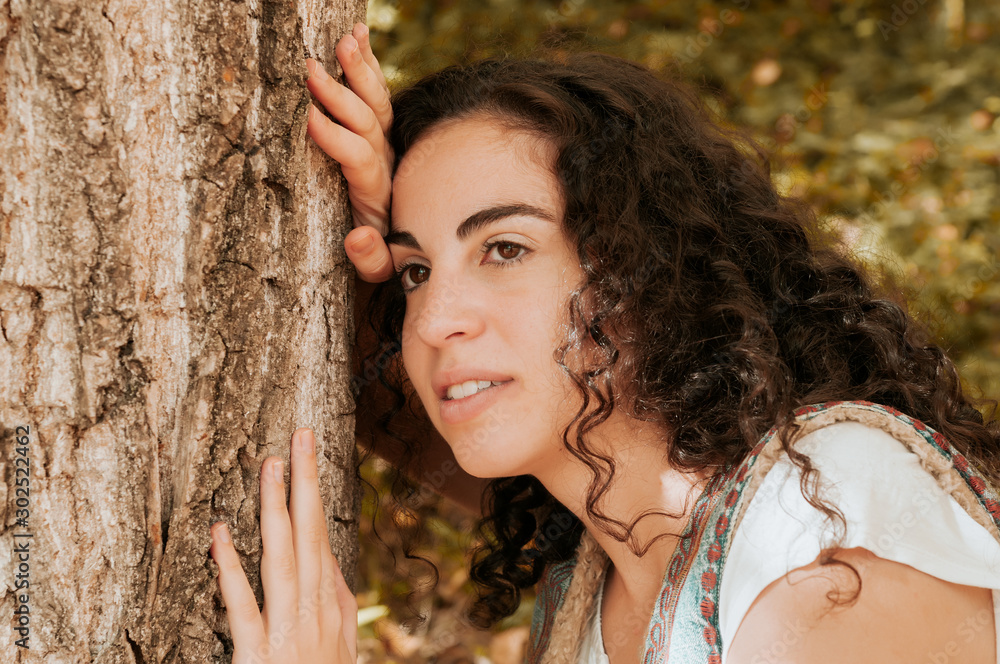 Young woman, dressed in casual clothes, with relaxed attitude, in a forest with autumn colors. Young woman, dressed in casual clothes, with relaxed attitude, in a forest with autumn colors.