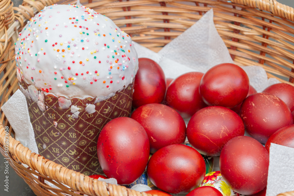 Easter spring cake with painted chicken eggs in a wicker basket