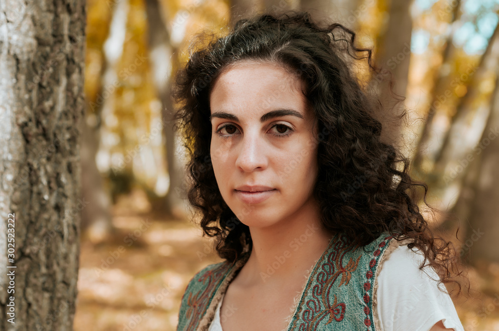 Young woman, dressed in casual clothes, with relaxed attitude, in a forest with autumn colors. Young woman, dressed in casual clothes, with relaxed attitude, in a forest with autumn colors.