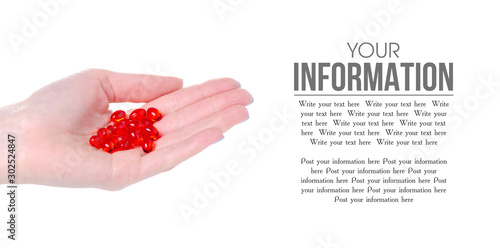 Red capsule medicine pharmacy in hand on white background isolation, space for text