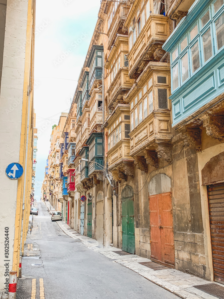 Typical narrow streets with colorful balconies in Valletta , Malta. Travel and tourism in Malta concept. Cityscape of Valletta. Architecture of Valetta.